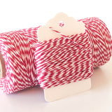 Red and white twisted twine on a blank white gift tag.