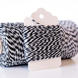 Black and white twisted twine wrapped around a white hang tag