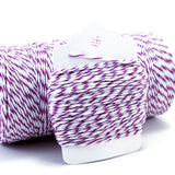 Baker's twine with a purple and white striped pattern, wrapped around a white paper tag.