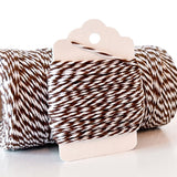 Twisted dark brown and white twine wrapped on a small cardboard hanger tag.