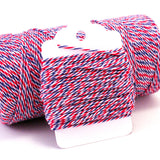 Airmail striped baker's twine in red, white and blue twisted strands wrapped around a white hang tag.